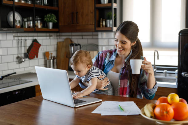istock Young mother juggling work and child care 1202919132