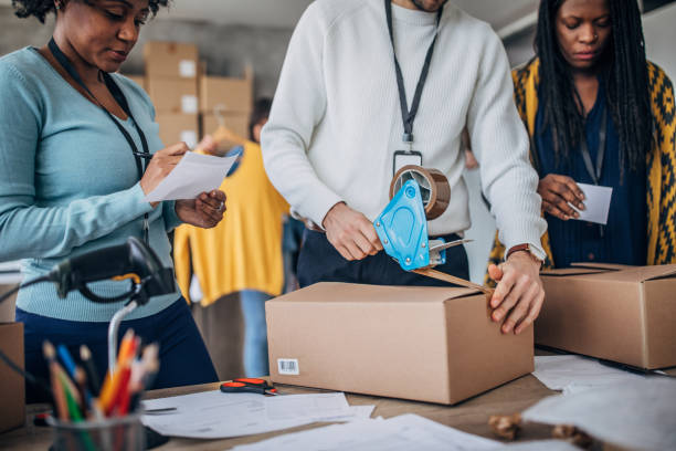 istock Diverse group of people arranging customers orders for drop shipping 1202920492