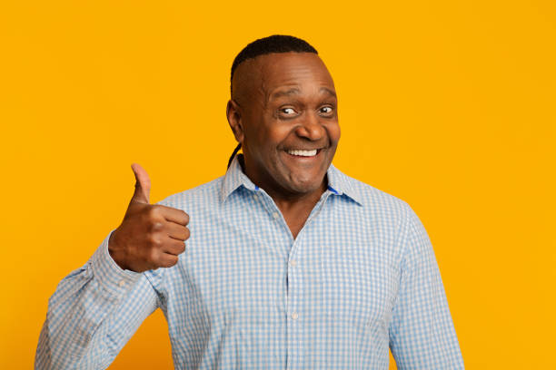 istock Happy middle aged african man gesturing thumb up 1202920564