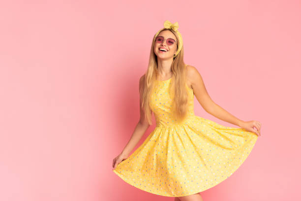 istock Cheerful young blonde woman dancing at pink studio 1202920816