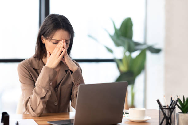 istock European manager doing nose massage at workplace 1202920946