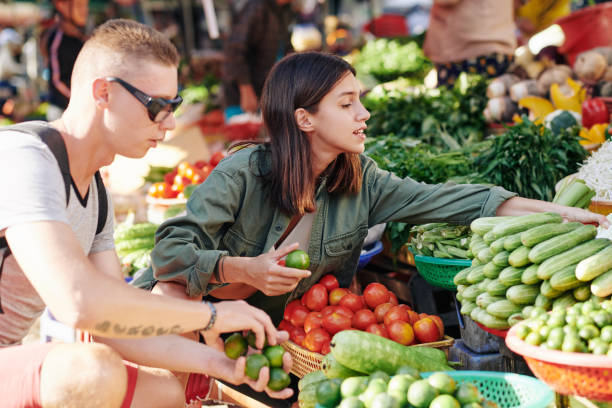 istock Couple Choosing Vegetables At Market 1202921903