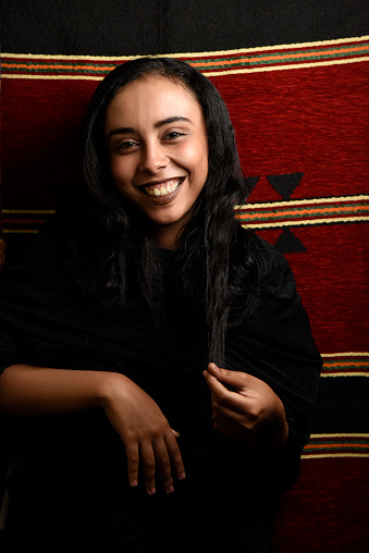 young beautiful middle eastern girl wearing Arabic Traditional Abbaya over on colorful background