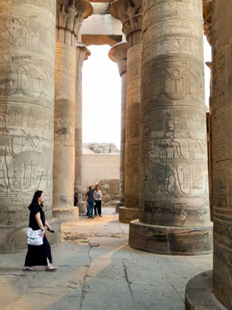 Kom Ombo, Egypt - 21 Okt, 2018: Woman walks between the large hieroglyph colums of the Kom Ombo temple