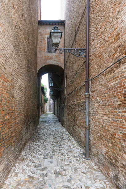 narrow street with arch in Forli, Italy