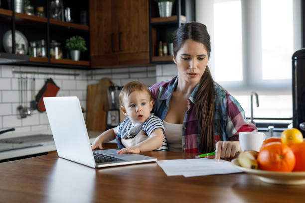 istock Young mother juggling work and child care 1202924003