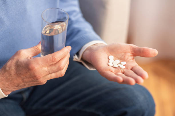istock Unrecognizable Gentleman Holding Pills Sitting On Sofa At Home, Cropped 1202925298
