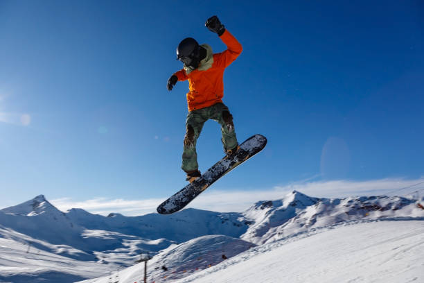 istock Snowboarder against the blue sky 1202925448