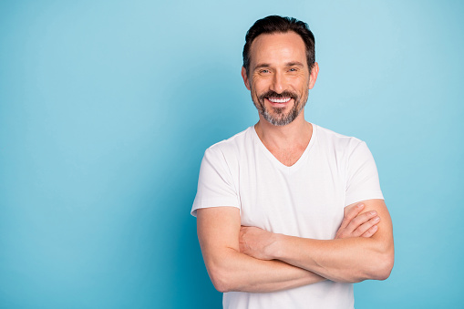 Portrait of his he nice attractive cheerful cheery glad content mature guy self-employed freelancer folded arms isolated over bright vivid shine vibrant teal green blue turquoise color background photo