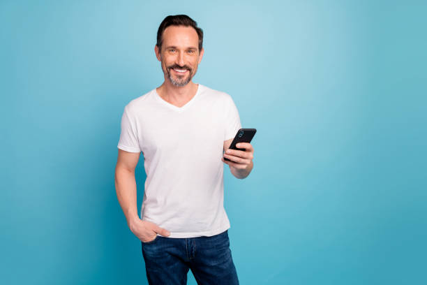 istock Portrait of his he nice attractive cheerful cheery guy freelancer spending free time using 5g app web isolated on bright vivid shine vibrant teal green blue turquoise color background 1202927926