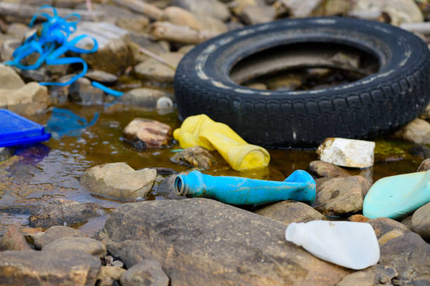 Plastic and styrofoam pollution from ocean on beach. Dirty spilled garbage waste on sea shore.