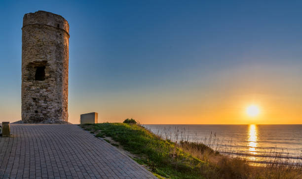 beautiful ocean sunset near torre del puerco, a historic watch tower in chiclana de la frontera, andalusia, spain. - 2844 fotografías e imágenes de stock