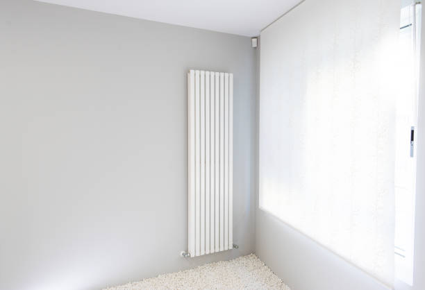 istock gray wall with white radiator next to illuminated window 1202930870