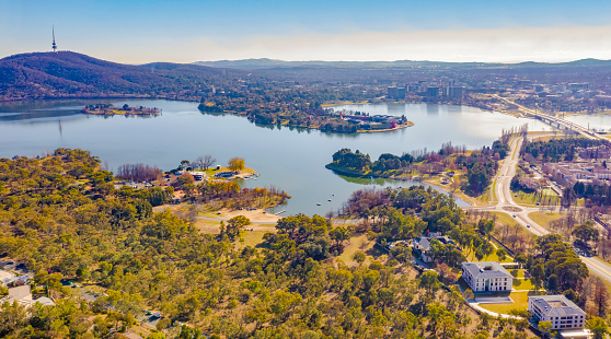 Panorama view of Canberra, the capital city of Australia, looking north over Lake Burley Griffin with Black Mountain and Telstra Tower to the left and Commonwealth Bridge at right
