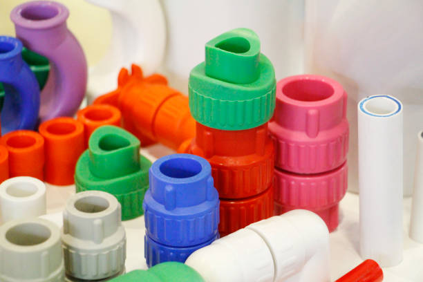 many colored plugs, screws, valves, fittings, pipes, plastic adapters. - propylene imagens e fotografias de stock