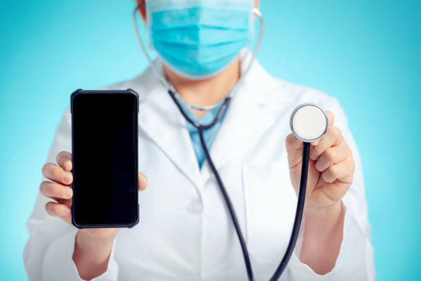doctor with stethoscope and smart phone in hand for medical exam concepts - telephone doctor medical exam healthcare and medicine imagens e fotografias de stock