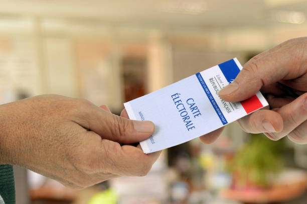 Present your voter card close-up of human hands and a French voter card voter id stock pictures, royalty-free photos & images