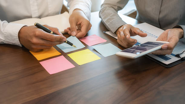 istock Business team brainstorming and discussing with financial data and report graph. Teamwork meeting working concept. 1202938969