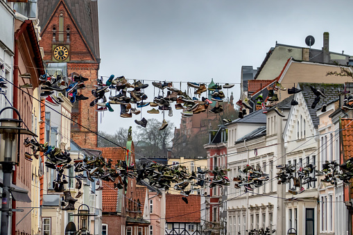 Hanging shoes in Flensburg main street, Northern Germany