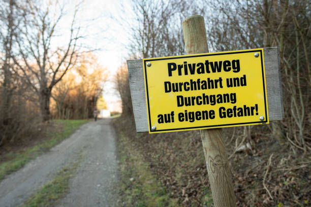 istock Yellow signpost for a private road in german 1202942949