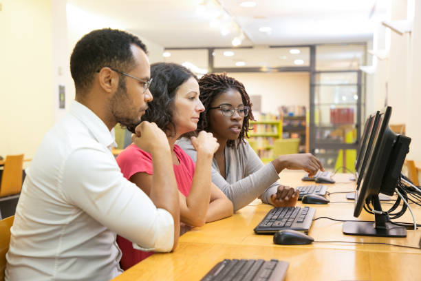 istock Focused young people talking while looking at computer monitor 1202943751