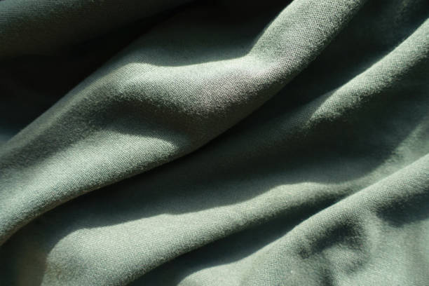 istock Simple dark green jersey fabric in soft folds 1202944155