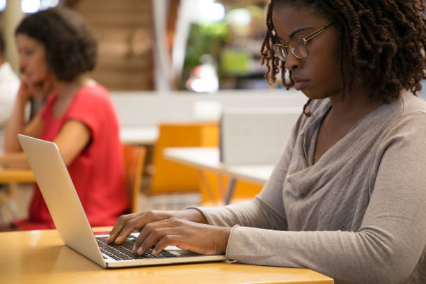 istock Thoughtful woman working with laptop at public library 1202950551