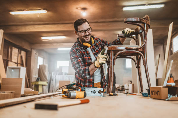 male furniture designer carefully sanding a chair frame - carpenter restoring furniture wood imagens e fotografias de stock