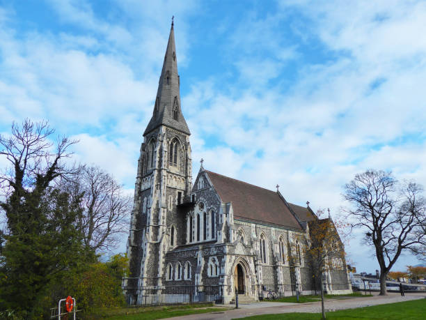 istock Gothic Anglican church with blue sky and trees 1202951466