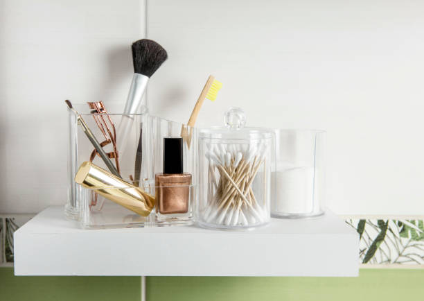 istock Make up products organizing in bathroom concept. Beauty products in organizer container box on tidy way on minimalist shelf. Cotton pads stacked, Q-tips and make up brushes. 1202951904