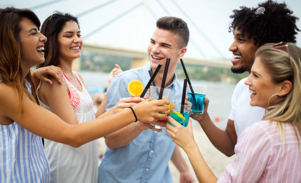 istock Multiracial group of friends enjoying a day at beach. 1202953400
