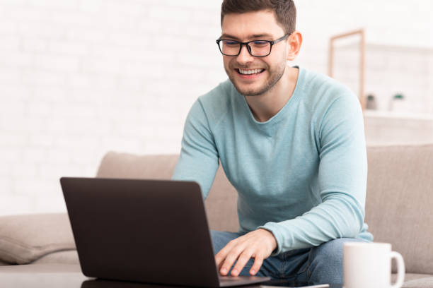 istock Freelancer Using Laptop Working Online Sitting On Sofa At Home 1202953449