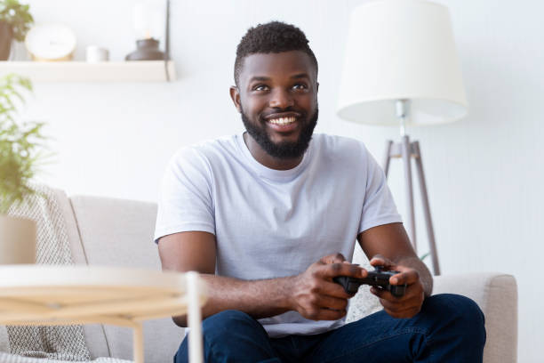istock African american gamer playing on gamepad at home 1202953464