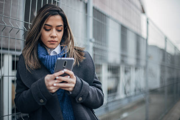 istock Woman on the street using smart phone 1202953552