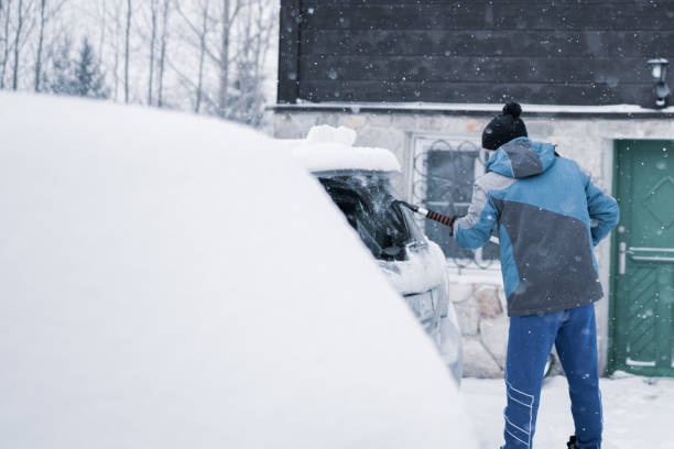 istock Scraping ice and snow from car window 1202955320