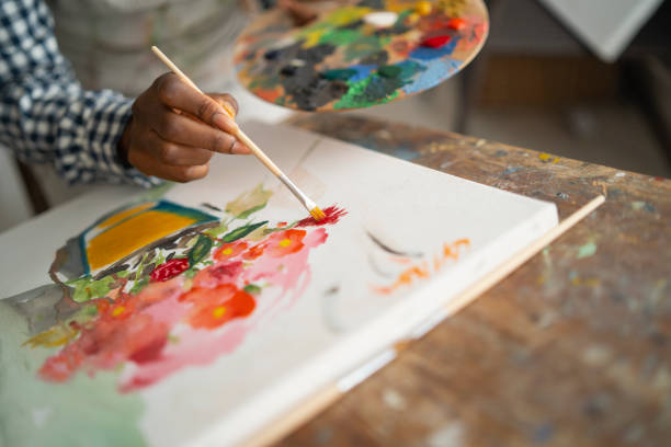 istock Female artist working in studio 1202955349