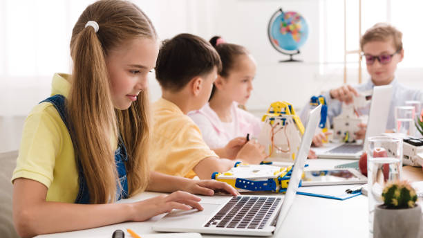 istock Girl watching scientific robotics video at lesson 1202955405