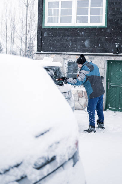 istock Scraping ice and snow from car window 1202955408
