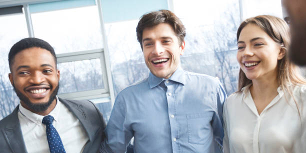 istock Happy colleagues bonding in circle and smiling 1202956538
