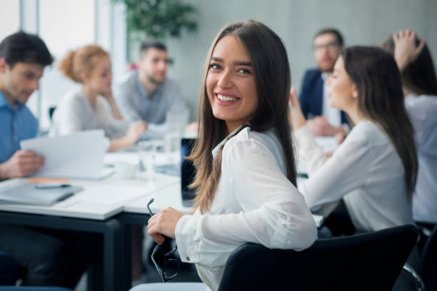 istock Positive secretary smiling to camera during meeting 1202956783