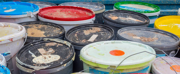 istock Panorama Old paint buckets on the construction site 1202956859