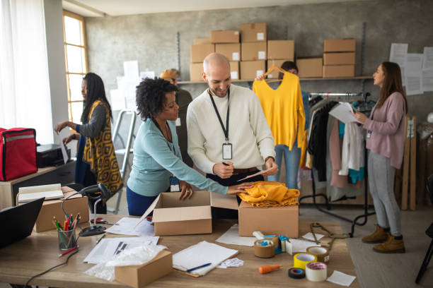 istock Workers checking the shipment list and preparing new orders for today 1202956879