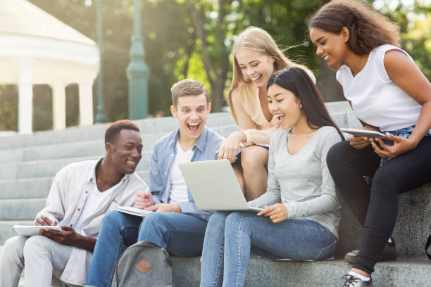 istock Excited friends checking test results online, using laptop 1202957495