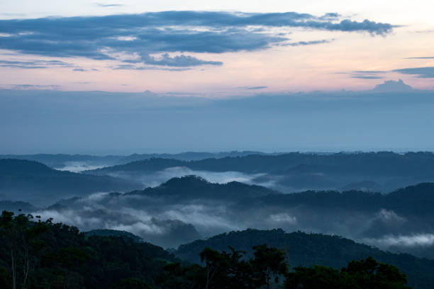 istock Mountains in silhouette with clouds fog 1202959466