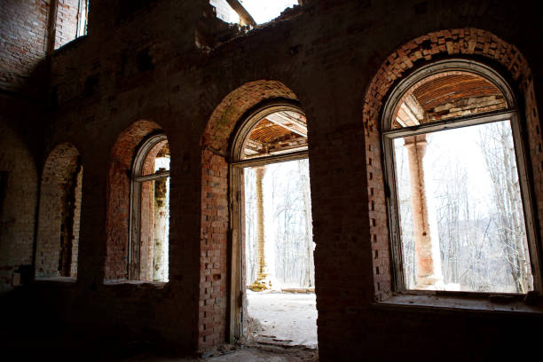 istock Chiaroscuro from a row of Windows in an old dilapidated building. 1202959713