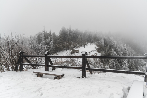 The viewpoint in the mountains in winter. Low clouds obscure the view