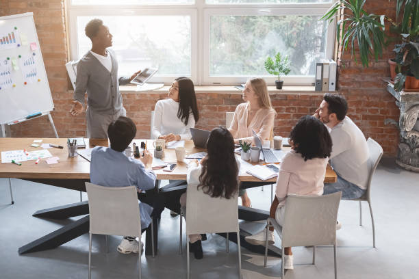 istock Black guy with digital tablet sharing business ideas with colleagues 1202961258