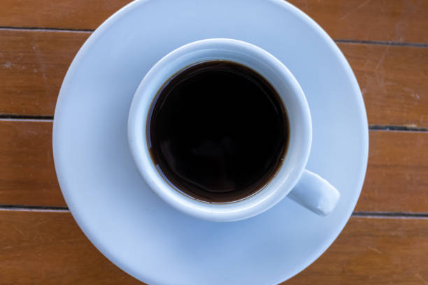 istock Black coffee in white cup and saucer 1202962379