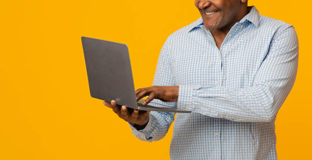 istock Mature african man typing on laptop, panorama 1202962744