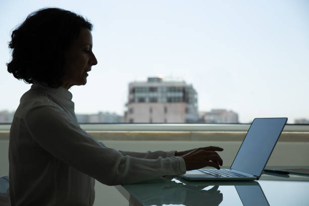 istock Serious middle aged businesswoman using laptop 1202963256